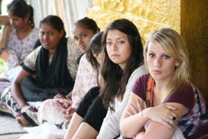Emily (far right) sits with Indian women at a microfinance repayment gathering.