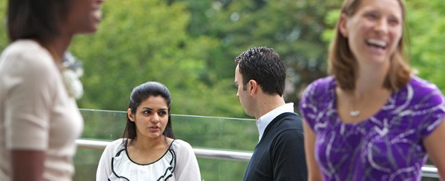Foster MBA students talking outside in courtyard