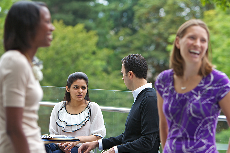 Foster MBA students talking outside in courtyard