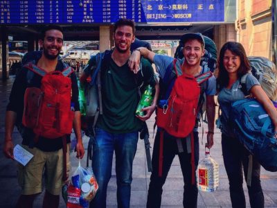 Foster grads at a train station abroad
