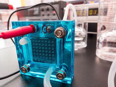 Flow batteries work by pumping water-based electrolyte solutions into a cell, such as the one shown here. Electrolytes are charged or discharged depending on whether a current is being applied from a solar cell or wind turbine, or if it is being extracted, like when it’s delivered to homes.