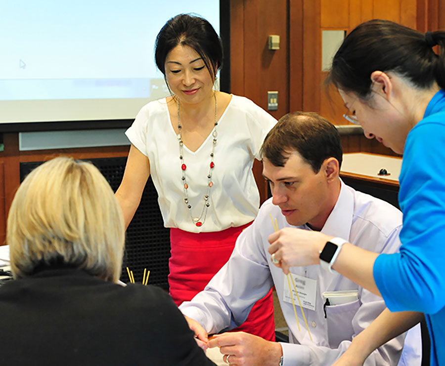 Associate Dean Jean Choy working with students