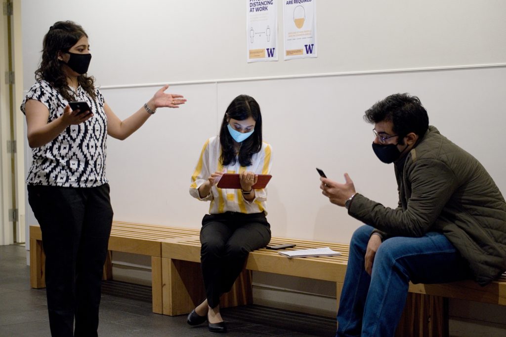 MBA students wearing masks and talking to each other