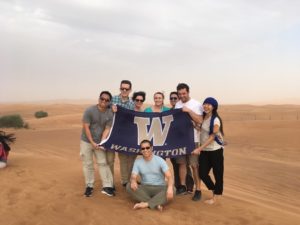 MBA students standing in sand dunes in the UAE