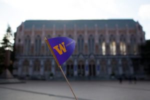 a uw penant flag held aloft in front of suzzalo library