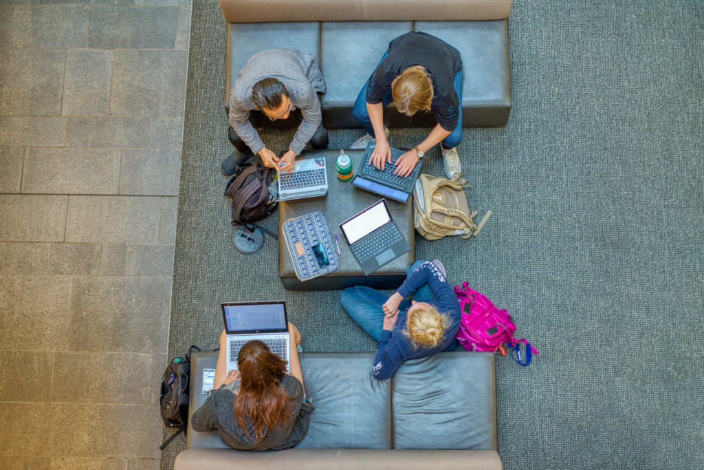 group of students studying on laptops at paccar hall