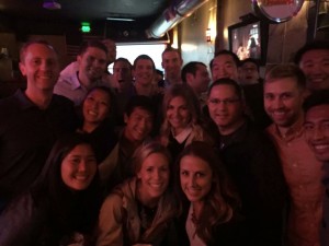 Nick Pernisco poses with a group of first year students during a Wednesday night Happy Hour