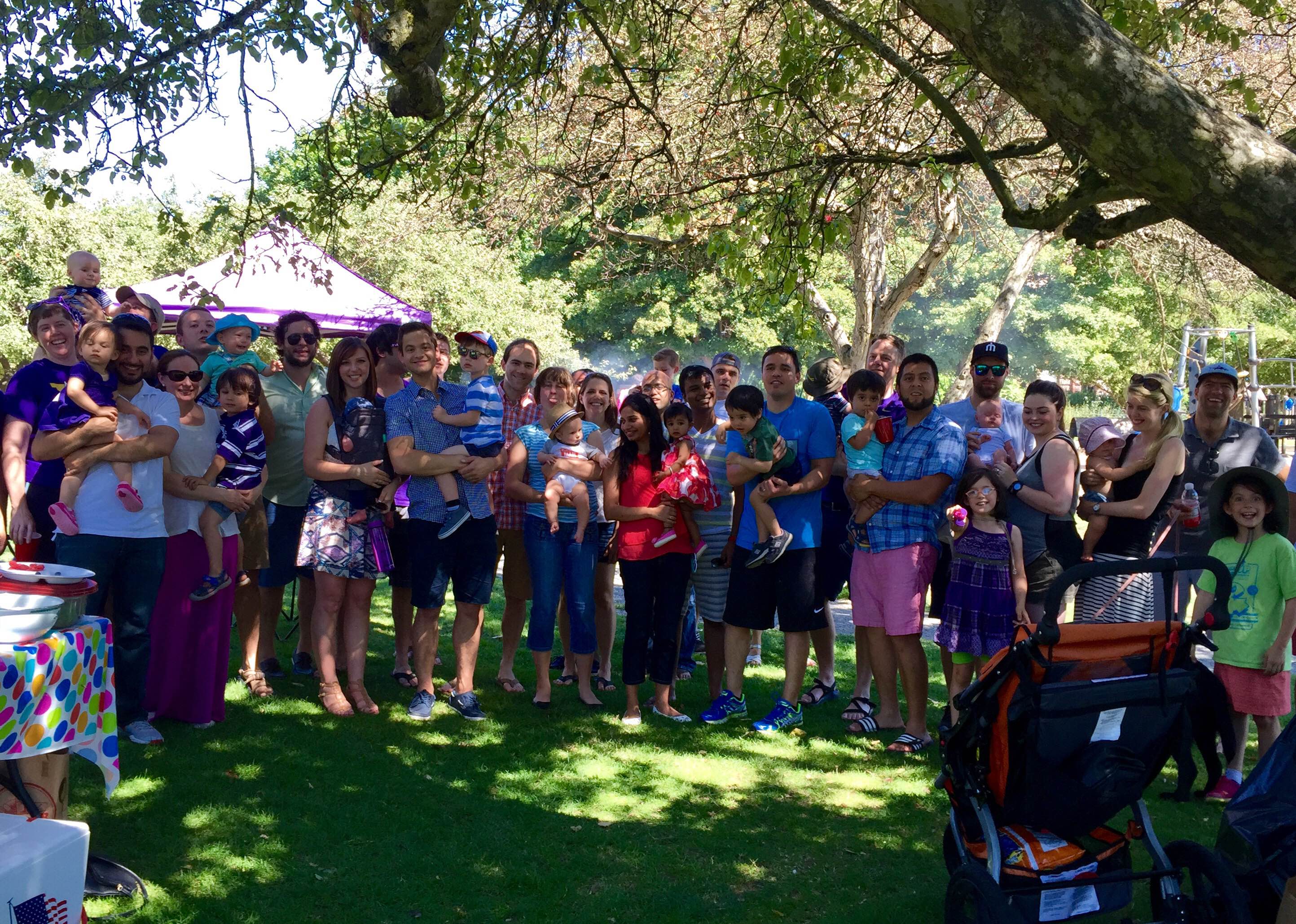 Classmates and their families pose for a group photo at the Class of 2016 Summer BBQ.