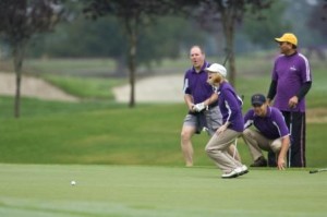 An alumni team comes up short on a birdie putt on hole 18 at Washington National